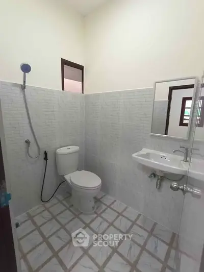 Modern bathroom with white tiles and sleek fixtures