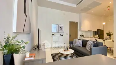 Modern living room with stylish decor and open kitchen layout, perfect for contemporary living.