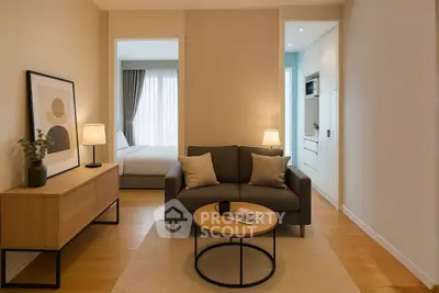Cozy living room with modern decor and view into a stylish bedroom