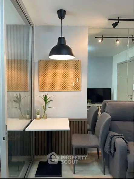 Cozy modern living room with stylish lighting and comfortable seating.