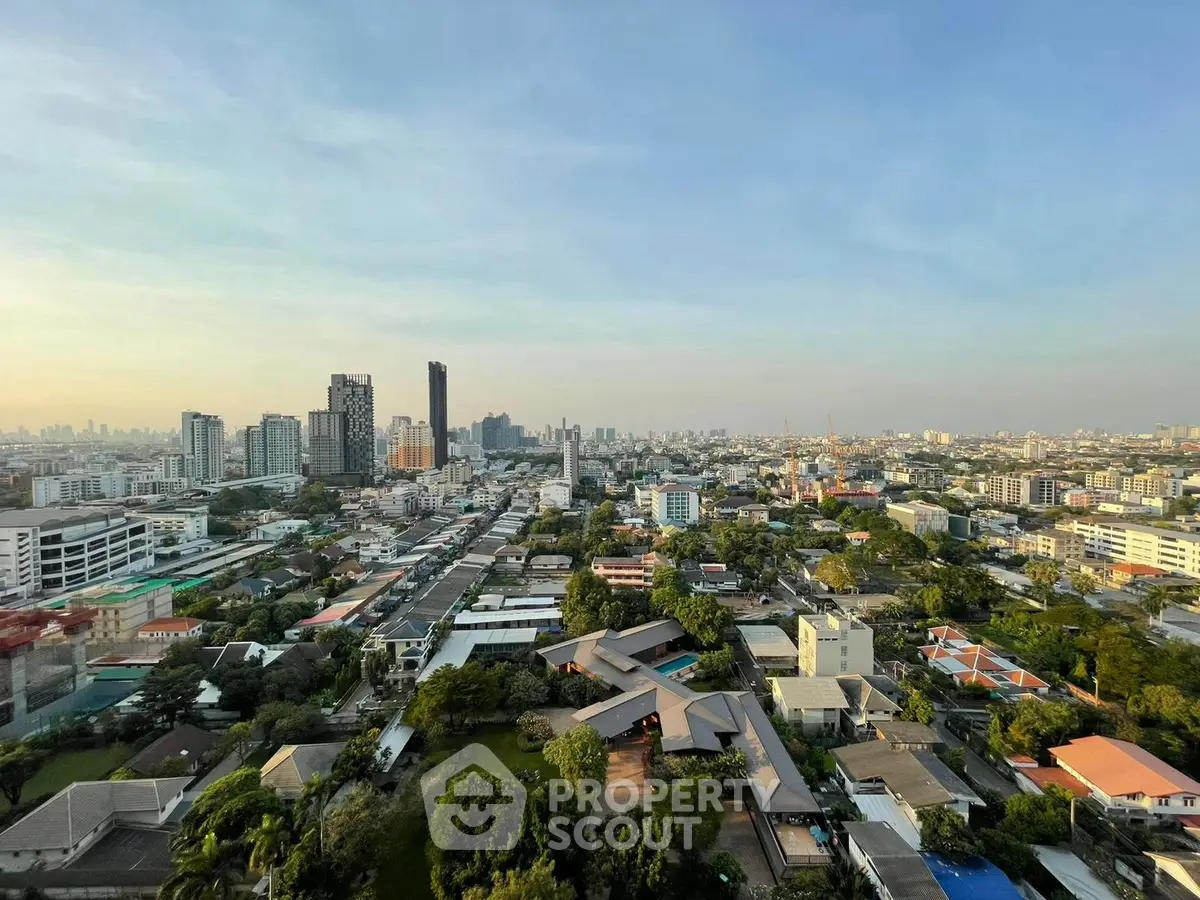 Stunning cityscape view from high-rise building showcasing urban skyline and lush greenery.