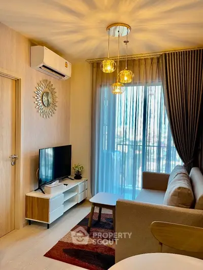 Modern living room with stylish decor, cozy sofa, and natural light from large window.