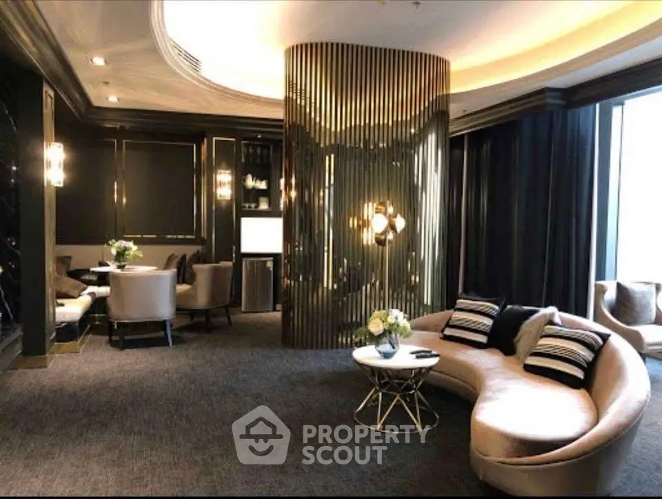 Luxurious modern living room with elegant curved sofa and stylish dining area, featuring ambient lighting and chic decor.