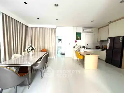 Spacious modern kitchen with dining area and sleek design