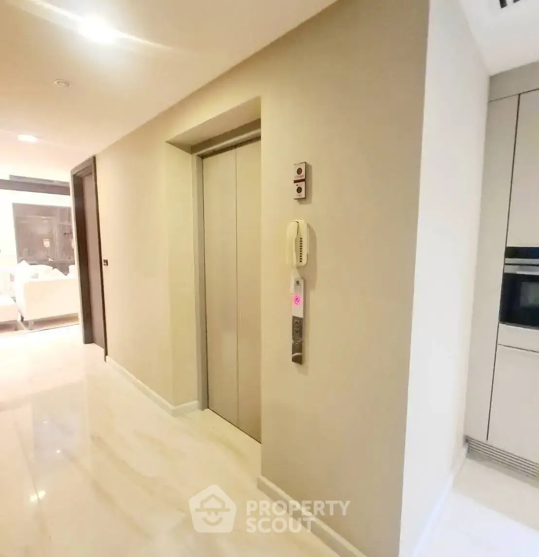 Modern apartment hallway with elevator access and sleek design.