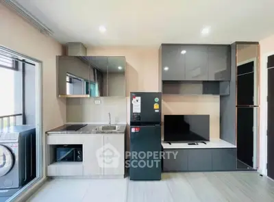 Modern kitchen with sleek cabinetry and appliances in a stylish apartment