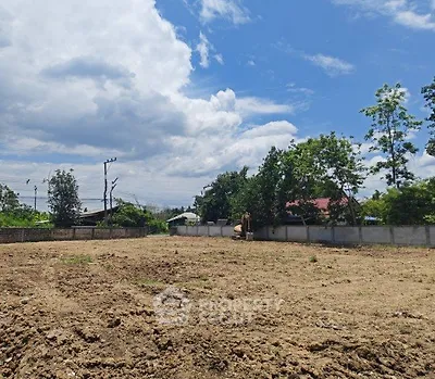 Expansive vacant land under a clear blue sky, ideal for development opportunities.