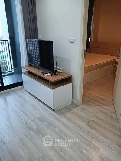 Modern apartment interior with TV stand and balcony view