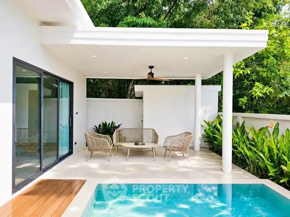 Stunning modern villa with private pool and lush greenery, perfect for luxurious outdoor living.