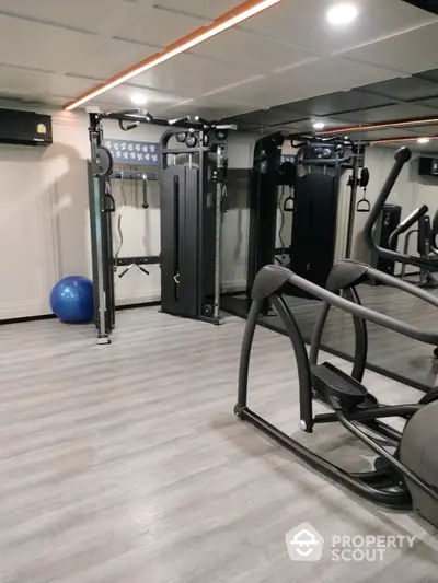 Modern gym with state-of-the-art fitness equipment and mirrored walls