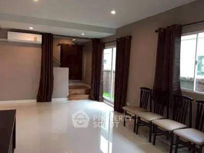 Spacious living room with modern design and ample natural light