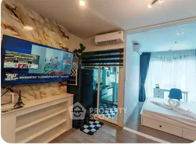 Modern apartment interior with stylish living room and cozy bedroom, featuring a large TV and air conditioning.
