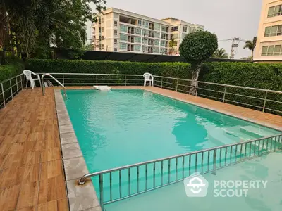 Luxurious residential pool area with modern apartment backdrop