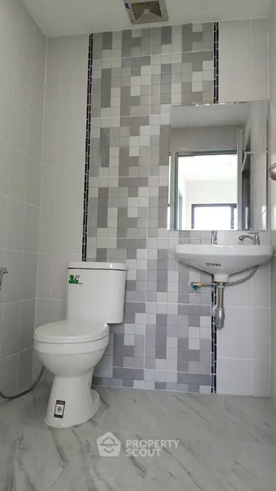 Modern bathroom with stylish tile design and sleek fixtures.