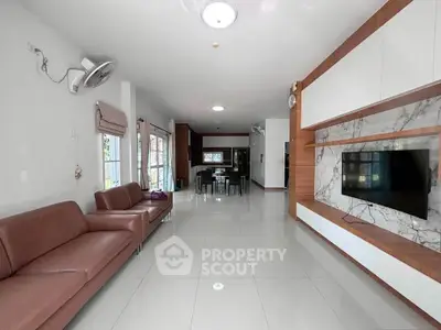 Spacious modern living room with sleek furniture and open layout, perfect for family gatherings.