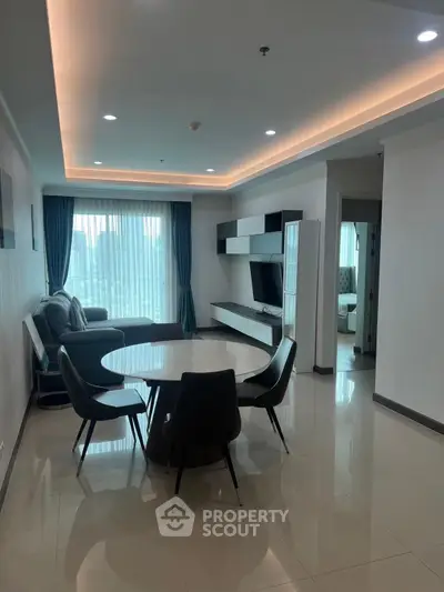 Modern living room with sleek furniture and city view, ideal for urban living.