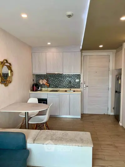 Chic modern kitchen with open layout and stylish backsplash in cozy apartment.