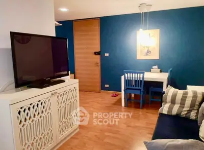 Charming living room with modern decor and vibrant blue accent wall