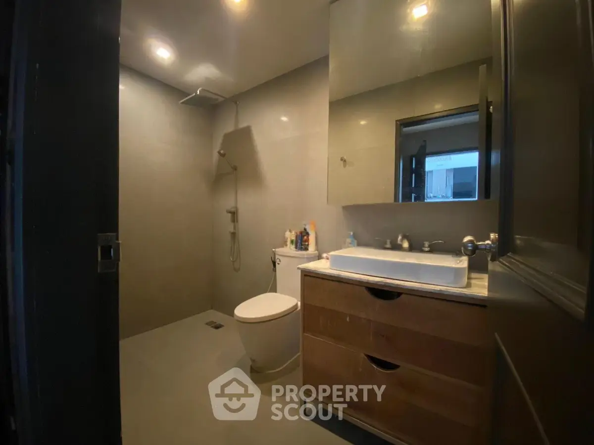 Modern bathroom with sleek fixtures and spacious shower area