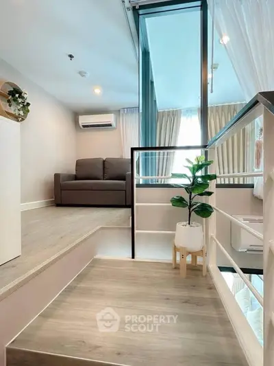 Modern duplex apartment with stylish interior and cozy living area, featuring large windows and elegant decor.