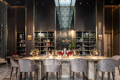 Luxurious modern library with elegant seating and ambient lighting in a high-end real estate property.