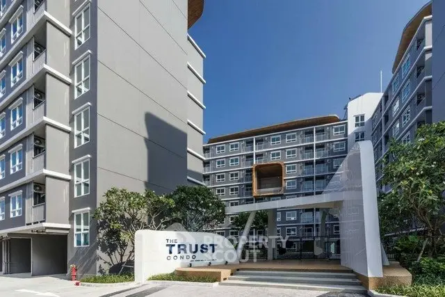 Modern condominium exterior with sleek design and lush greenery at The Trust Condo.