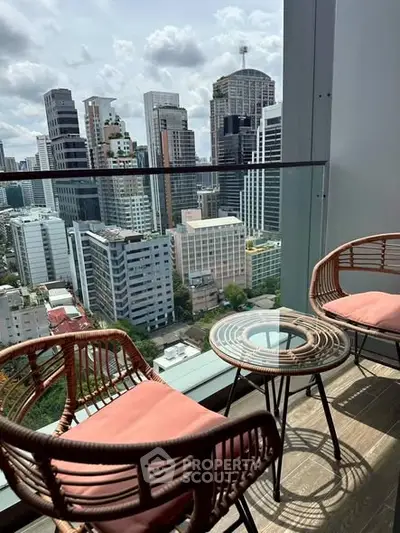 Stunning city view from a modern balcony with stylish seating, perfect for relaxation.