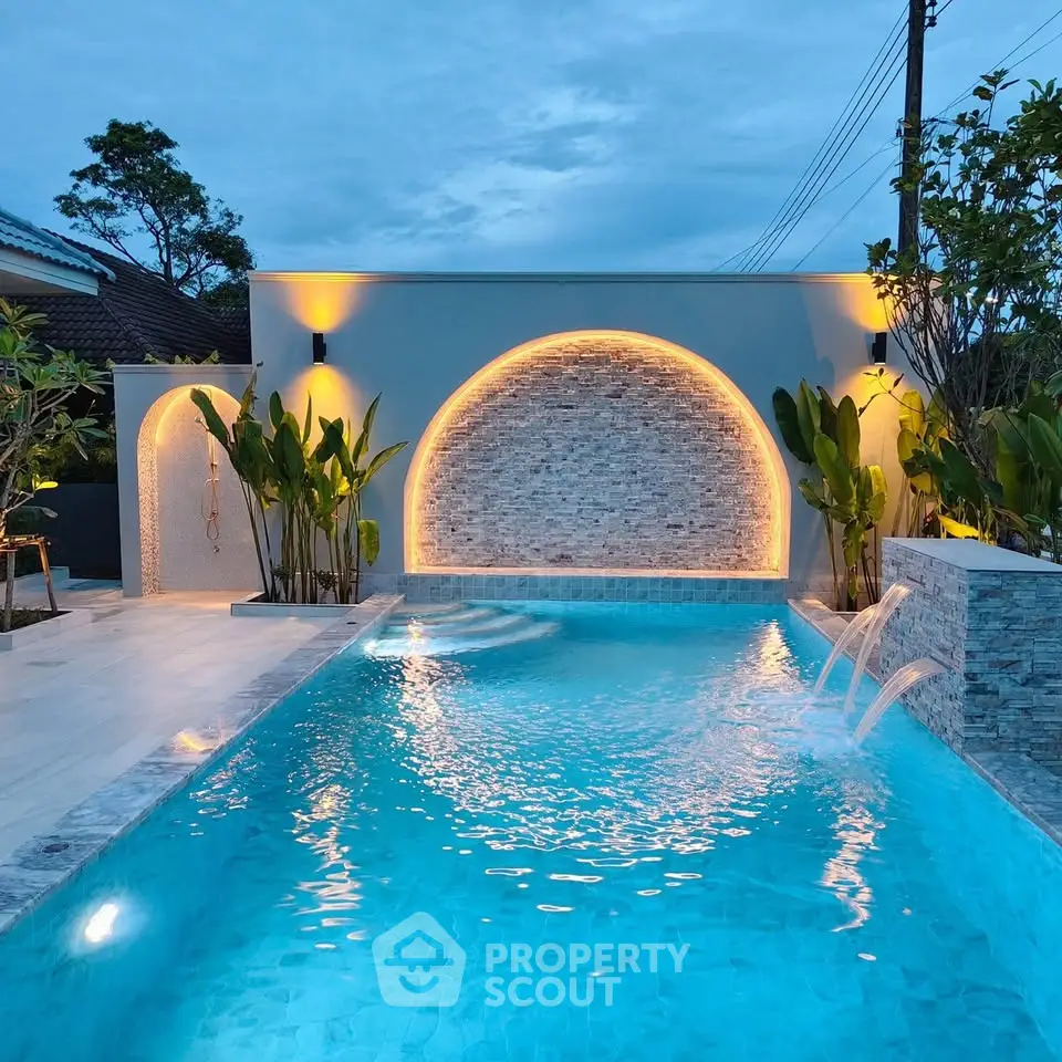 Luxurious outdoor pool with elegant lighting and modern design, perfect for relaxation and entertainment.