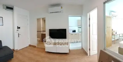Modern apartment interior with living room, kitchen, and bedroom view