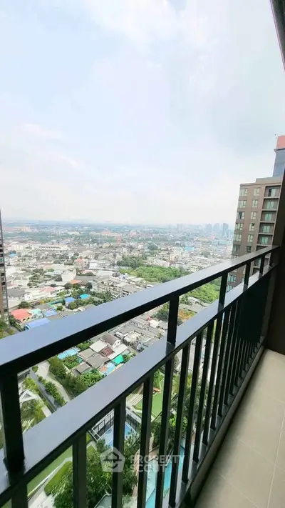 Stunning high-rise balcony view overlooking cityscape and residential area.