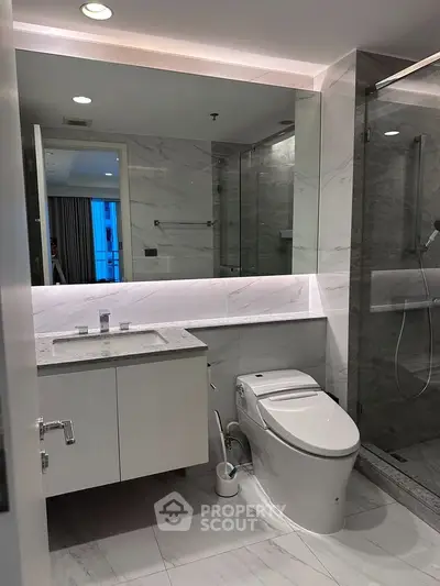Luxurious modern bathroom with sleek fixtures and elegant marble finishes.