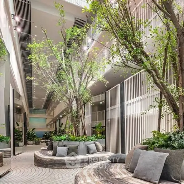 Luxurious modern building interior with lush greenery and stylish seating area.