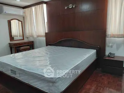 Spacious bedroom with elegant wooden furniture and natural light