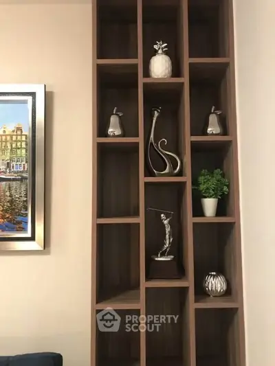 Elegant wooden shelving unit with decorative items in modern living room.