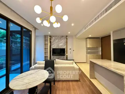 Modern open-layout living room with elegant lighting and stylish furniture