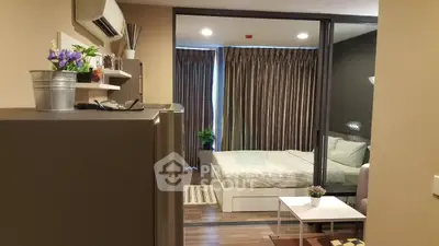Modern bedroom with sliding glass doors and stylish decor in a cozy apartment.