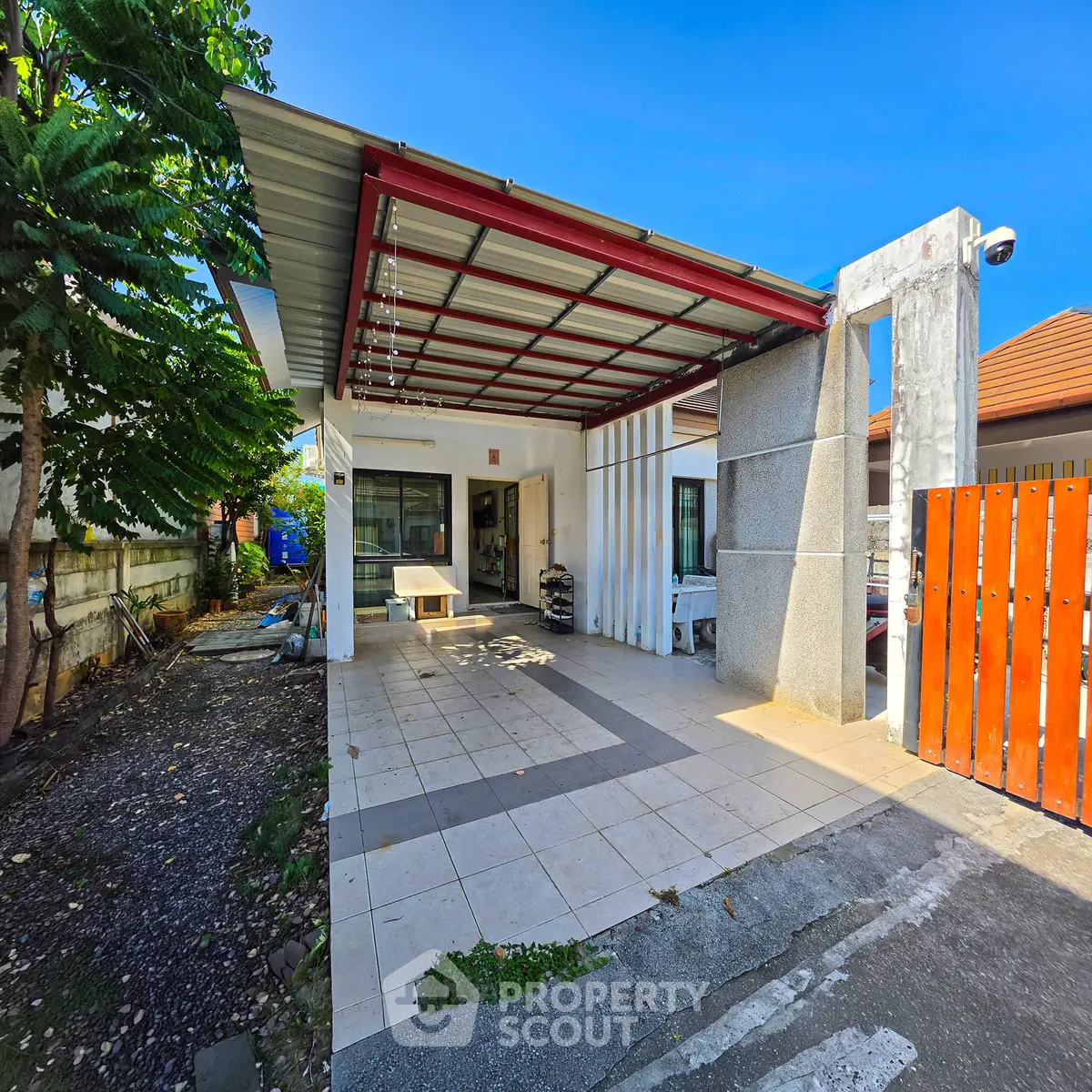 Charming single-story home with spacious carport and modern exterior design, perfect for family living.