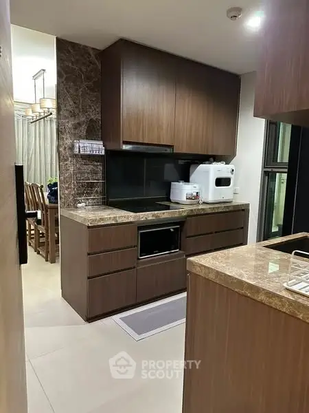 Modern kitchen with sleek wooden cabinets and marble countertops