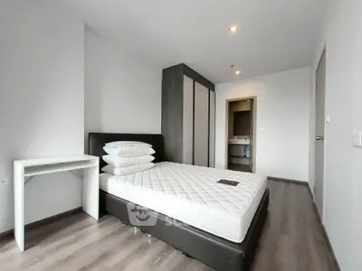 Modern minimalist bedroom with sleek flooring and ample closet space