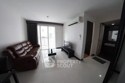 Modern living room with leather sofa and balcony access in a stylish apartment.