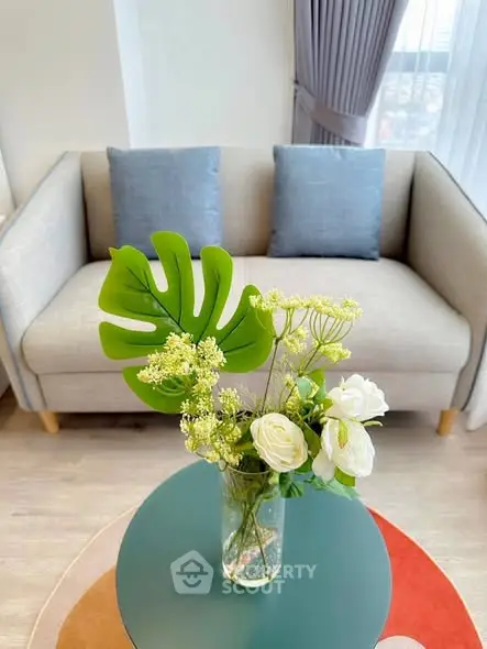 Stylish living room with modern sofa and floral centerpiece, perfect for cozy relaxation.