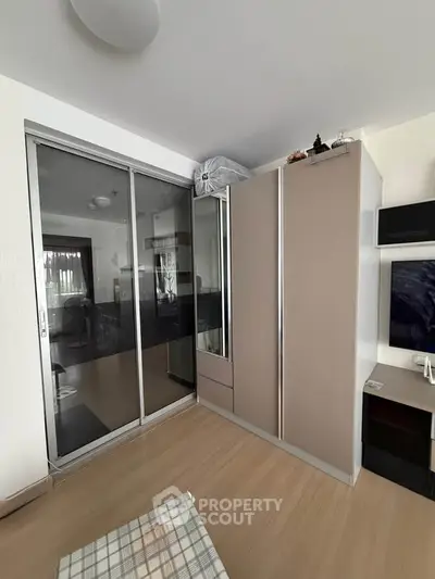 Modern living room with sleek sliding door wardrobe and stylish decor
