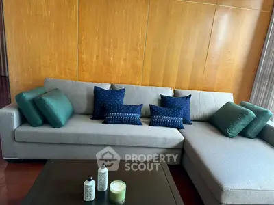 Modern living room with stylish grey sectional sofa and decorative pillows.