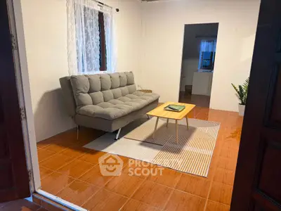 Cozy living room with modern sofa and stylish decor, perfect for relaxation and comfort.