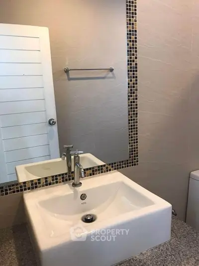 Modern bathroom with sleek sink and stylish mirror design