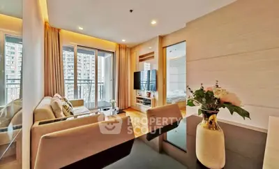 Modern living room with elegant decor and balcony view in a high-rise apartment.