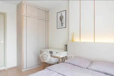 Modern bedroom with sleek design, built-in wardrobe, and cozy workspace.