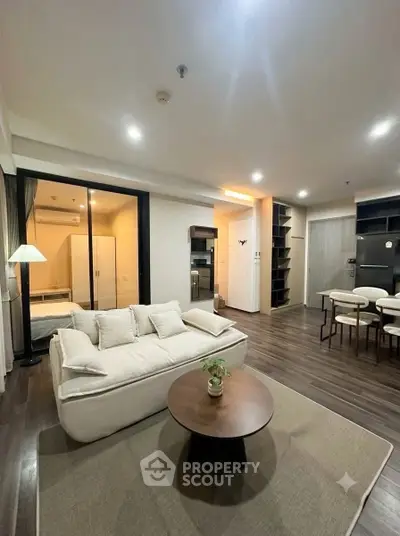 Modern open-plan living room with cozy seating and stylish dining area