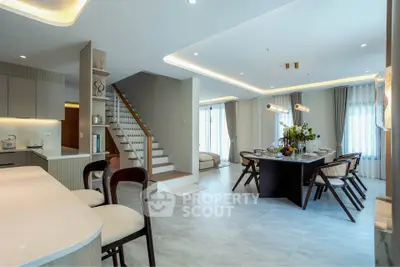 Spacious modern living and dining area with elegant lighting and open layout