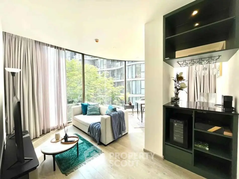 Modern living room with large windows and stylish decor in a contemporary apartment.